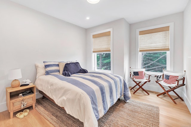 888 Oldfield Rd, Fairfield, CT 06824 - bedroom with multiple windows, wood finished floors, and recessed lighting