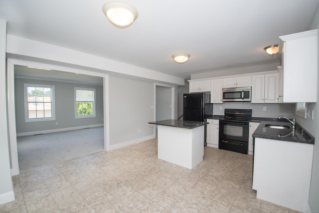 783 Naugatuck Ave, Milford, CT 06461 - kitchen featuring black appliances, a center island, dark countertops, white cabinets, and open floor plan