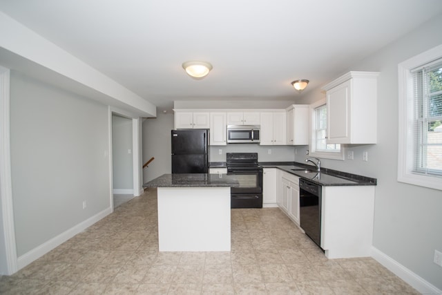 783 Naugatuck Ave, Milford, CT 06461 - kitchen featuring black appliances, a center island, white cabinets, and dark stone countertops