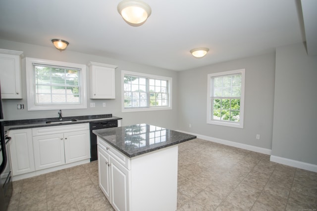 783 Naugatuck Ave, Milford, CT 06461 - kitchen with dishwasher, a center island, dark stone countertops, and white cabinetry