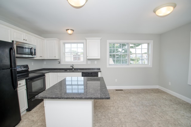 783 Naugatuck Ave, Milford, CT 06461 - kitchen featuring black appliances, a center island, white cabinets, and dark stone countertops