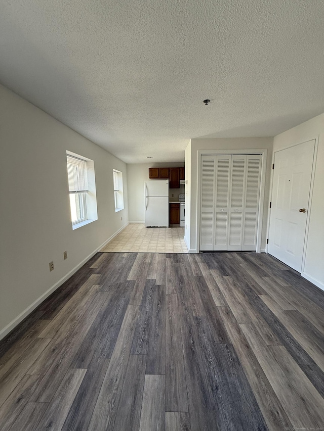 449 Judd Sq Unit 449, Wallingford, CT 06492 - unfurnished living room with a textured ceiling and dark wood finished floors