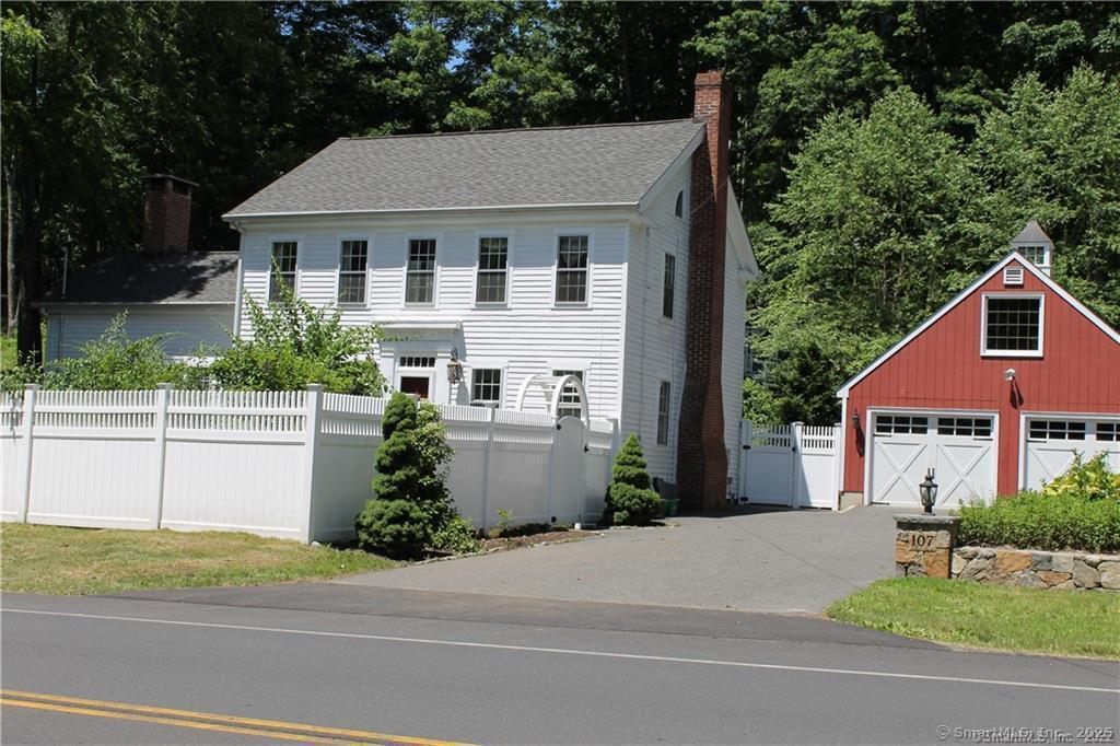 107 Berkshire Rd, Newtown, CT 06482 - colonial-style house with a chimney, a garage, and an outbuilding