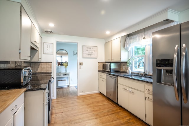 16 Westview Dr, Bethel, CT 06801 - kitchen featuring appliances with stainless steel finishes, tasteful backsplash, light wood-style floors, recessed lighting, and dark stone counters