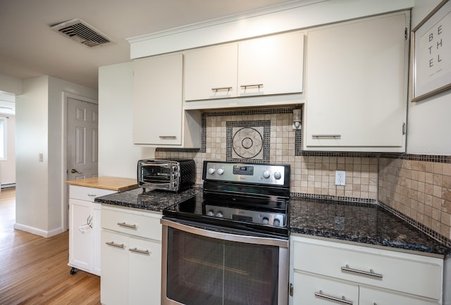 16 Westview Dr, Bethel, CT 06801 - kitchen with electric stove, light wood-style flooring, decorative backsplash, and dark stone counters