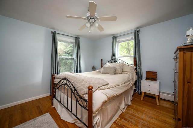 16 Westview Dr, Bethel, CT 06801 - bedroom with a baseboard heating unit, wood finished floors, and ceiling fan