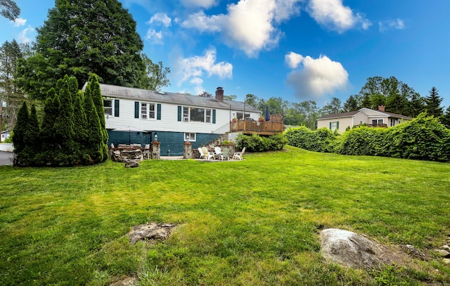 16 Westview Dr, Bethel, CT 06801 - back of property with a chimney, a deck, a yard, and a patio