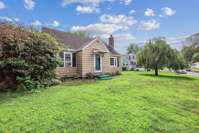 17 Burke Rd, Vernon, CT 06066 - view of front of home featuring a chimney, a front yard, and roof with shingles