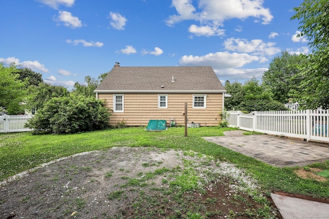 17 Burke Rd, Vernon, CT 06066 - rear view of property featuring a patio, a shingled roof, and a chimney