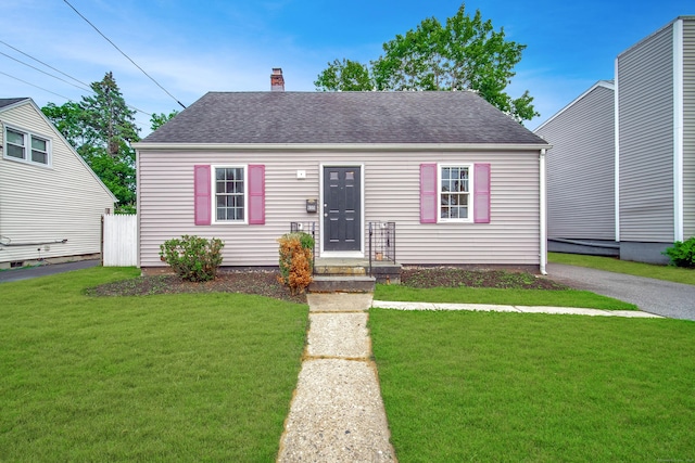 635 Ruth St, Bridgeport, CT 06606 - view of front of house with a front lawn, a chimney, and roof with shingles