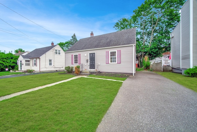 635 Ruth St, Bridgeport, CT 06606 - view of front of property with a front lawn, a chimney, and roof with shingles