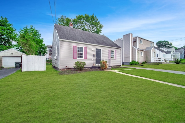 635 Ruth St, Bridgeport, CT 06606 - view of front facade featuring an outdoor structure, a front yard, a chimney, a garage, and roof with shingles