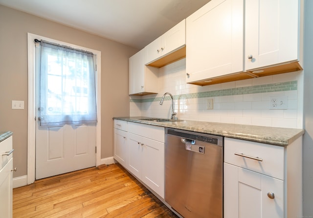 635 Ruth St, Bridgeport, CT 06606 - kitchen featuring dishwasher, light wood-style flooring, tasteful backsplash, and dark stone countertops