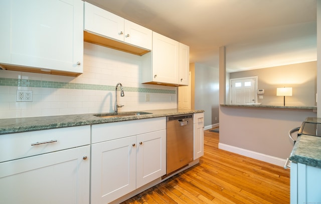635 Ruth St, Bridgeport, CT 06606 - kitchen with stainless steel appliances, light wood-style flooring, tasteful backsplash, white cabinets, and stone counters