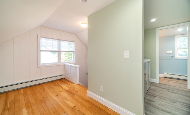 635 Ruth St, Bridgeport, CT 06606 - additional living space with baseboard heating, separate washer and dryer, light wood-style flooring, vaulted ceiling, and healthy amount of natural light