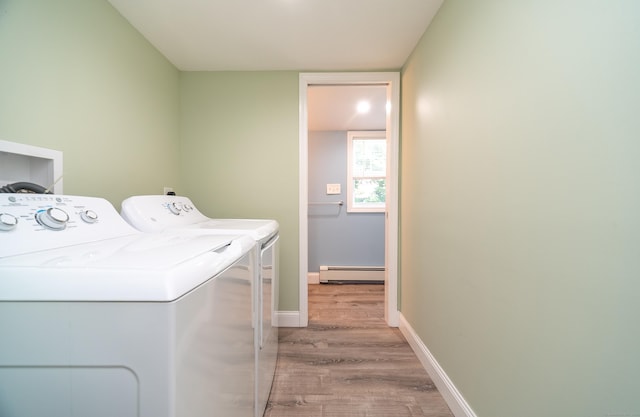 635 Ruth St, Bridgeport, CT 06606 - laundry room featuring washing machine and clothes dryer, a baseboard radiator, and wood finished floors