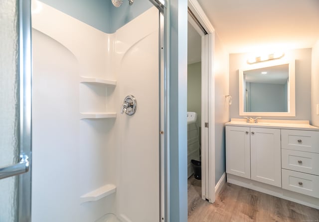 635 Ruth St, Bridgeport, CT 06606 - full bathroom featuring a shower, wood finished floors, and vanity