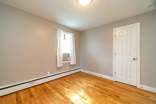 635 Ruth St, Bridgeport, CT 06606 - empty room featuring baseboard heating, light wood-type flooring, and a smoke detector