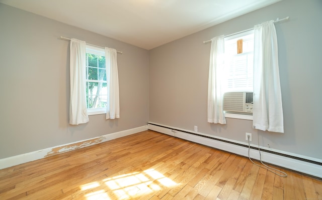 635 Ruth St, Bridgeport, CT 06606 - empty room with a baseboard heating unit and light wood-type flooring