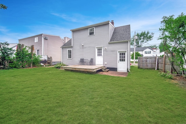 635 Ruth St, Bridgeport, CT 06606 - back of house with a shingled roof, a wooden deck, and a chimney