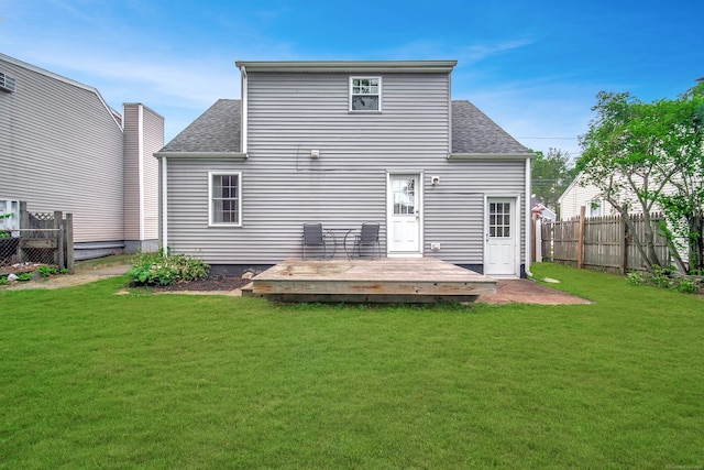635 Ruth St, Bridgeport, CT 06606 - rear view of house with a fenced backyard, a deck, and roof with shingles