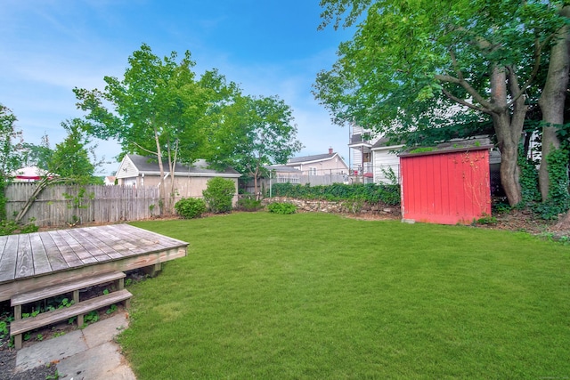 635 Ruth St, Bridgeport, CT 06606 - fenced backyard featuring a storage unit and a deck