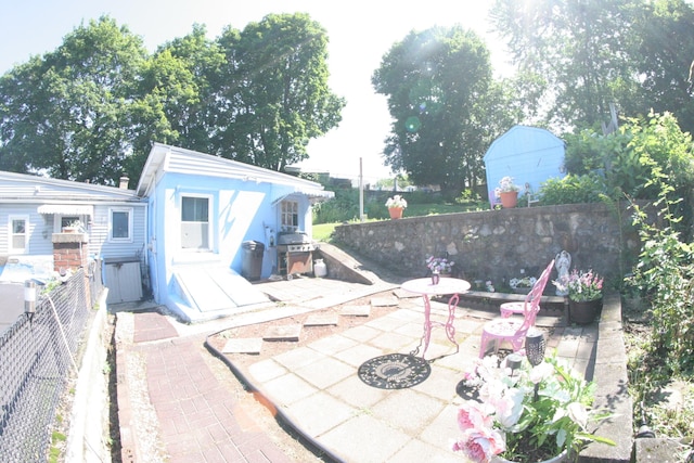 375 Baldwin St, Waterbury, CT 06706 - fenced backyard featuring a patio area, a grill, and an outdoor fire pit
