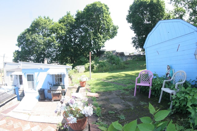 375 Baldwin St, Waterbury, CT 06706 - view of green lawn with a patio area and a storage unit