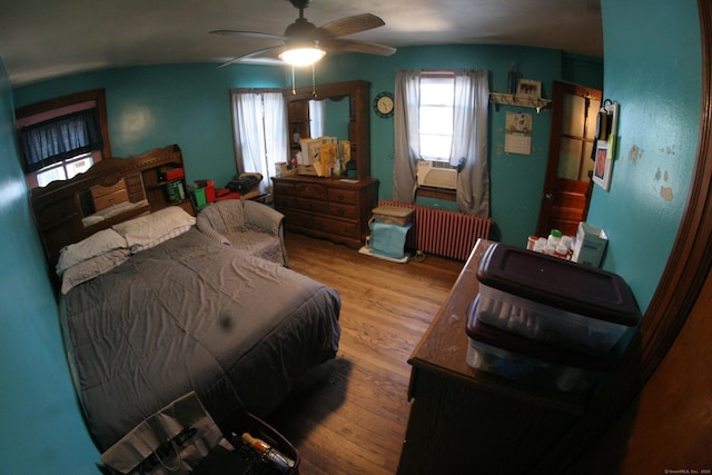 375 Baldwin St, Waterbury, CT 06706 - bedroom featuring radiator heating unit, wood finished floors, cooling unit, and ceiling fan