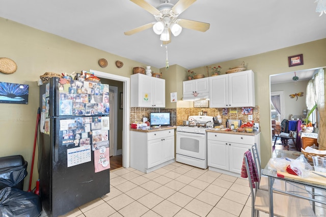78 Church St, Hamden, CT 06514 - kitchen with white gas range oven, freestanding refrigerator, decorative backsplash, light tile patterned floors, and white cabinetry