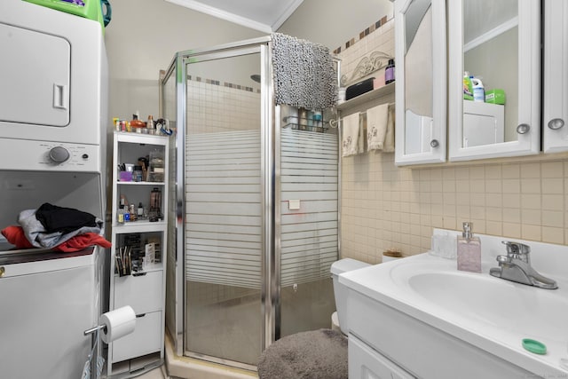 78 Church St, Hamden, CT 06514 - full bath featuring stacked washer and clothes dryer, vanity, a stall shower, ornamental molding, and backsplash