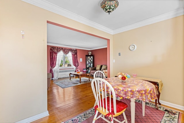 90 Strawberry Hill Ave Unit 3, Stamford, CT 06902 - dining area featuring radiator, ornamental molding, and wood finished floors
