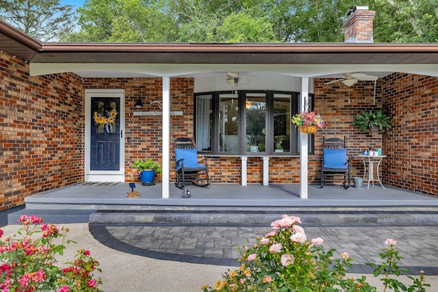 449 Mohegan Avenue Parkway, Waterford, CT 06375 - view of exterior entry featuring ceiling fan, covered porch, brick siding, and a chimney