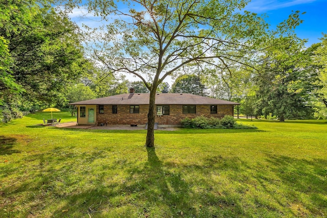 449 Mohegan Avenue Parkway, Waterford, CT 06375 - rear view of property with a lawn, a patio area, brick siding, and a chimney