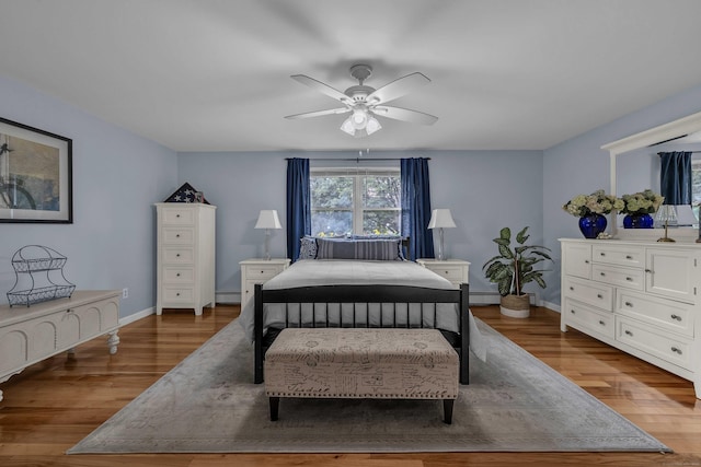 449 Mohegan Avenue Parkway, Waterford, CT 06375 - bedroom with wood finished floors, baseboard heating, ceiling fan, and a baseboard heating unit
