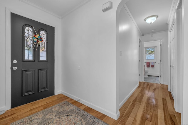 449 Mohegan Avenue Parkway, Waterford, CT 06375 - foyer featuring crown molding, light wood-style flooring, and arched walkways