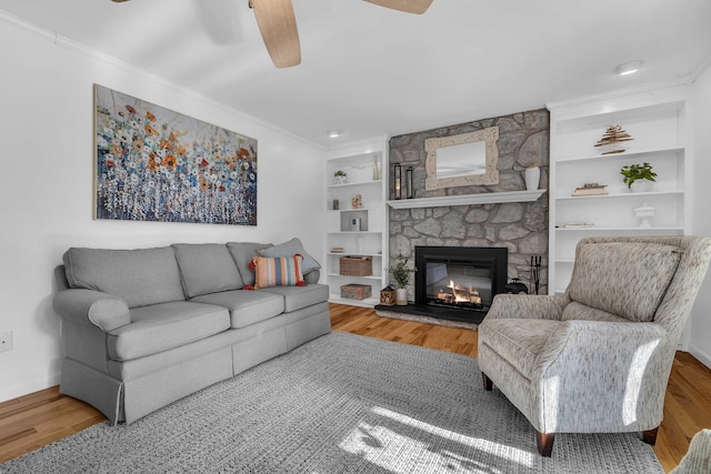 449 Mohegan Avenue Parkway, Waterford, CT 06375 - living area with a fireplace, ceiling fan, wood finished floors, ornamental molding, and built in shelves