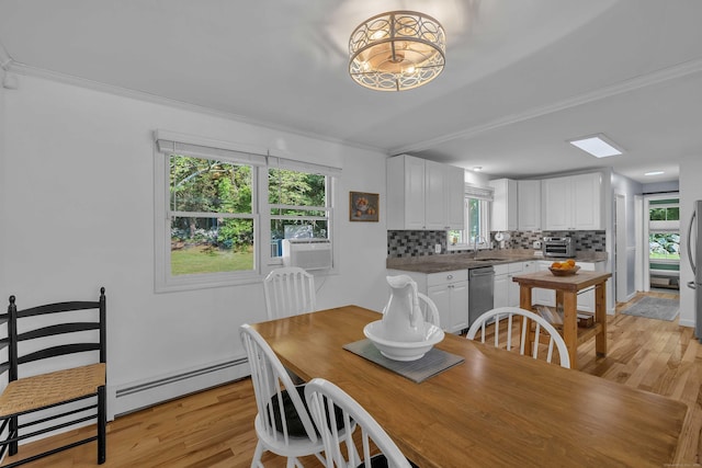 449 Mohegan Avenue Parkway, Waterford, CT 06375 - dining space featuring light wood-style floors, crown molding, healthy amount of natural light, and a baseboard radiator