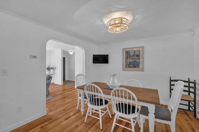 449 Mohegan Avenue Parkway, Waterford, CT 06375 - dining space featuring arched walkways, ornamental molding, and light wood-style flooring