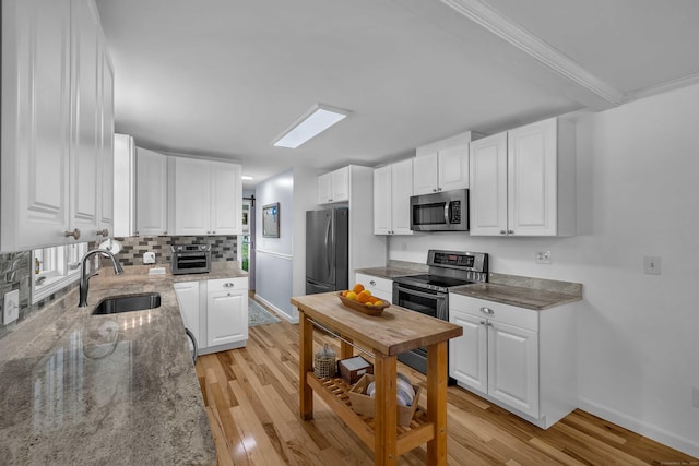 449 Mohegan Avenue Parkway, Waterford, CT 06375 - kitchen with stainless steel appliances, light wood finished floors, white cabinets, light stone countertops, and ornamental molding