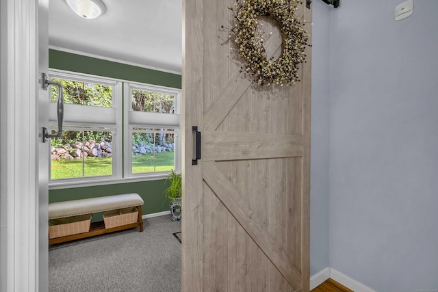 449 Mohegan Avenue Parkway, Waterford, CT 06375 - bedroom featuring a barn door, crown molding, and carpet flooring