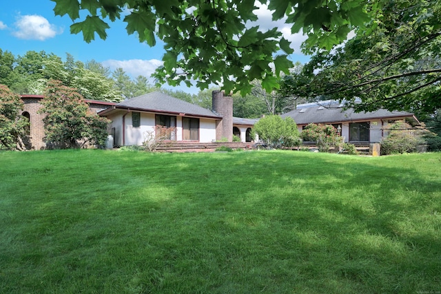 3853 Congress St, Fairfield, CT 06824 - view of front of property featuring a chimney and a front lawn