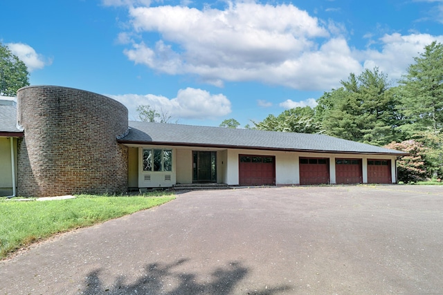 3853 Congress St, Fairfield, CT 06824 - view of front of property featuring a garage, asphalt driveway, and a chimney