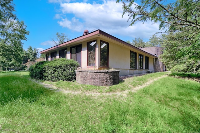 3853 Congress St, Fairfield, CT 06824 - view of side of property featuring stucco siding and a chimney