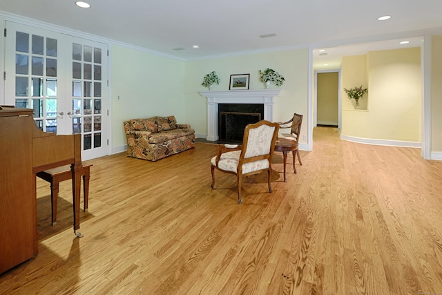 3853 Congress St, Fairfield, CT 06824 - living room with french doors, a fireplace with flush hearth, light wood-type flooring, recessed lighting, and crown molding