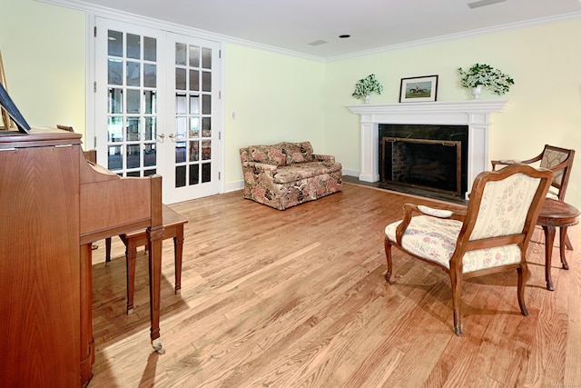 3853 Congress St, Fairfield, CT 06824 - living area featuring french doors, wood finished floors, a premium fireplace, and crown molding