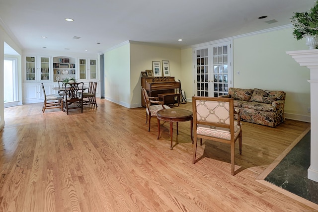 3853 Congress St, Fairfield, CT 06824 - living area with french doors, built in shelves, ornamental molding, light wood finished floors, and recessed lighting