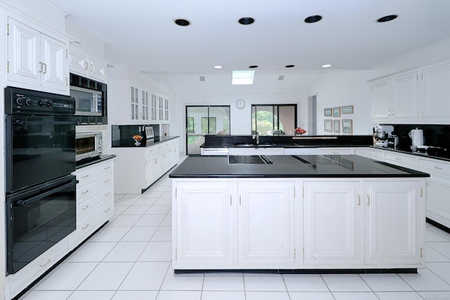 3853 Congress St, Fairfield, CT 06824 - kitchen with dark countertops, stainless steel microwave, white cabinets, and recessed lighting