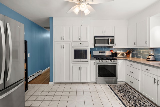 17 Valley Stream Dr, Danbury, CT 06811 - kitchen featuring appliances with stainless steel finishes, a baseboard heating unit, tasteful backsplash, ceiling fan, and white cabinetry