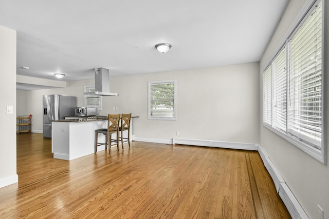 198 Macon Dr, Bridgeport, CT 06606 - kitchen featuring wall chimney exhaust hood, stainless steel appliances, dark countertops, and light wood-type flooring